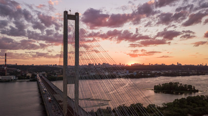 Naklejka premium aerial night city view, luminous buildings and bridge. Drone shot.