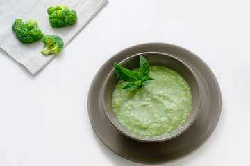 Vegetarian soup of broccoli puree on a white background. The concept of healthy eating.