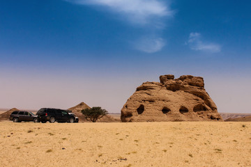 The sport utilities vehicles near the Cathedral Stone, an isolated natural sandstone formation and...
