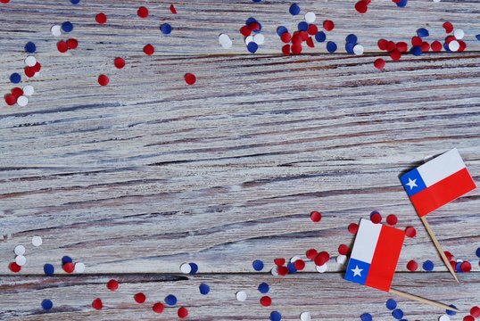 September 18, happy independence day of Chile. memorial day for independence. the concept of patriotism. mini flags with confetti on white wooden background