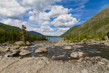 Multinsky averadge lake in Altai mountains. Picturesque landscape with transparent rapid water flow through stones. Summer time.
