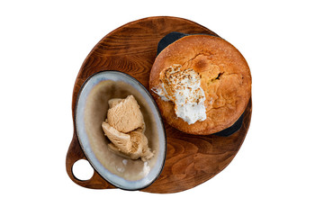 Traditional american apple pie served on a wooden tray and decorated with icecream isolated at white background.