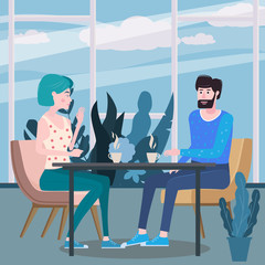 Loving couple is drinking coffee in cafe. A man and a woman in love on date are sitting at a table