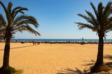 Summertime full beach with peoples from Gandia-Spain