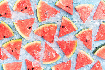 Watermelon slice popsicles on a blue rustic wood background