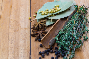 spices and herbs over head shot on a wooden board