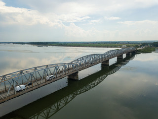 Obraz premium Aerial Drone Flight: View of the bridge over the river with cars. Olt river, Romania