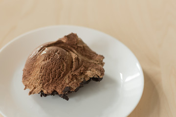 Chocolate and brownie ice cream on wooden table background. Plate with with icecream top view.