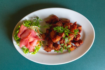Deep fried pork three big soya sauce with vegetables on whites dish