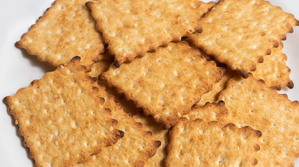 Macro photo of brown dietary low-calorie crispy cereal cracker with sesame dressing close-up on a white background