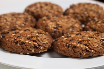 Macro photo of brown dietary low-calorie fitness cereal biscuits with sprinkling closeup on white background.