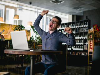 business man with laptop in cafe