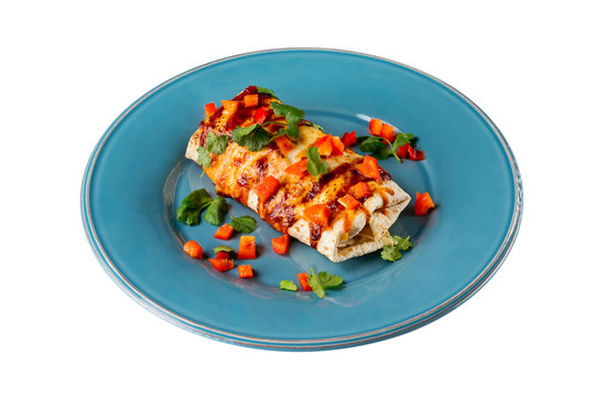 Mexican traditional meal - chicken breast enchiladas served with chilli sauce on a plate isolated at white background.