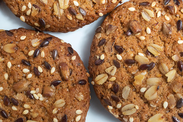 Macro photo of brown dietary low-calorie fitness cereal biscuits with sprinkling closeup on white background.