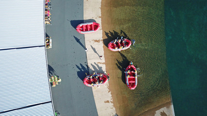 Aerial top view of rafting boats with people getting ready into the river
