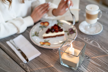 cherry cheesecake with latte in a cafe. Homemade breakfast with coffee. Great morning mood