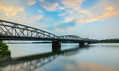 Dawn at Trang Tien Bridge. This is a Gothic architectural bridge spanning the Perfume river from the 18th century designed by Gustave Eiffel in Hue, Vietnam