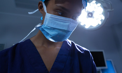Female surgeon performing operation in operating room at hospital