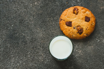 Cookes and milk on a gray background.