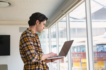 Male executive using laptop in the conference room at office