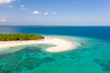 Fototapeta na wymiar Patawan island. Small tropical island with white sandy beach. Beautiful island on the atoll, view from above. Nature of the Philippine Islands.