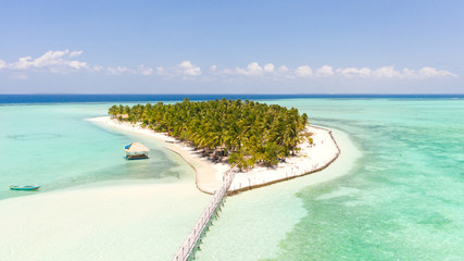 Fototapeta na wymiar Seascape with a paradise island. Onok Island Balabac, Philippines. A small island with a white sandy beach and bungalows. Philippine Islands.