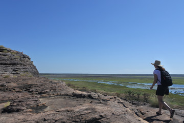 Fototapeta na wymiar Woman tourist hiking at Ubirr rock art site in Kakadu National Park Northern Territory of Australia