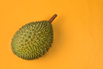 durian  on bright yellow background with copyspace