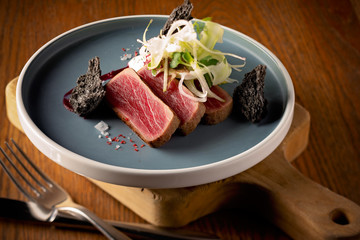 Tuna steak on a grey round plate
