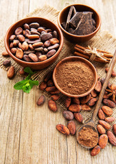 Natural  cocoa powder, chocolate and cocoa beans  on a wooden background