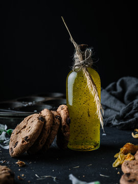 chocolate chip cookies next to a bottle