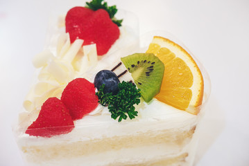 Fresh milk cakes and a variety of fruits that are beautifully decorated, look attractive.