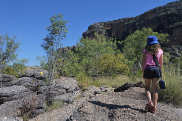 Fototapeta premium Young girl hiking at Burrungkuy Nourlangie rock art site in Kakadu National Park Northern Territory of Australia