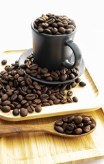 Coffee beans in a coffee mug on a white background