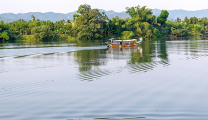 Cruise lonely boat at Perfume river. This is eco-tourism means peaceful waterways in the imperial city in Hue, Vietnam