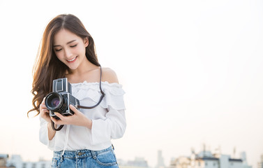 Portrait of beautiful asian woman photographer look taking photo. Cool young girl model with retro...