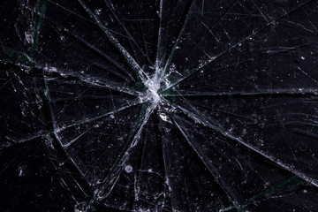 A glass surface that took a bad hit and broke, featuring a big scary hole (maybe a bullet), with a...