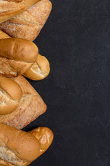 Assortment of fresh bread on dark background