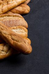 Assortment of fresh bread on dark background