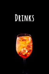 Stylish alcoholic aperol spritz trendy cocktail with orange slice on black background. Vertical photo. Drinks wording