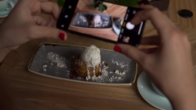 Closeup of Young Woman Taking Photo Of Food And Coffee With Phone in Restaurant 4K. Female Taking Pictures of Dessert.