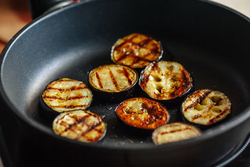 Eggplants are fried in a skillet. Close-up.