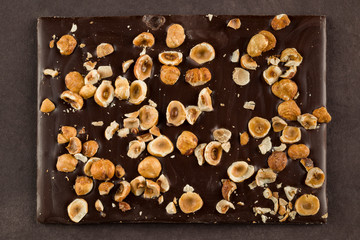 hazelnut dark chocolate bar on brown background