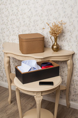 Box with folded things in the interior of the apartment