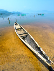 Lonely wooden fishing boat on the lagoon looking forward to going to the sea as a wish for people to look forward to good things in the vast sea