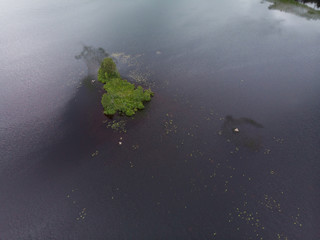 isolated aerial view of the island that every summer floats to the surface in the lake at Gammelstilla, Gästrikland, Sweden. 