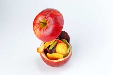 HHealthy vegetable chips yellow sweet potato purple sweet potato carrot green radish green beans and shiitake mushrooms in hollow red apple white background