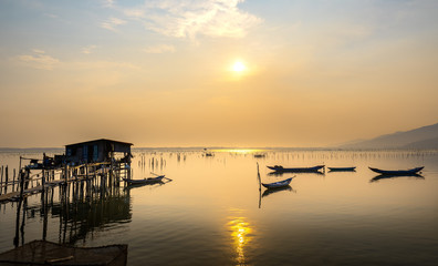 Obraz premium The simple life of fishermen in Lap An lagoon with small wooden boats for living on the water in Hue, Vietnam
