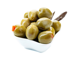 Green olives stuffed with red paprika isolated on white.