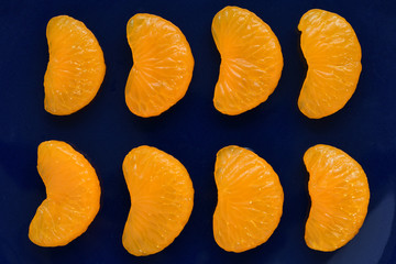 Mandarin orange fruits isolated on dark blue background